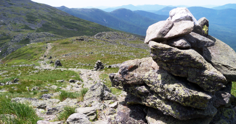 Rock cairn marking trail symbolizing leadership stewardship and maintaining trust structure
